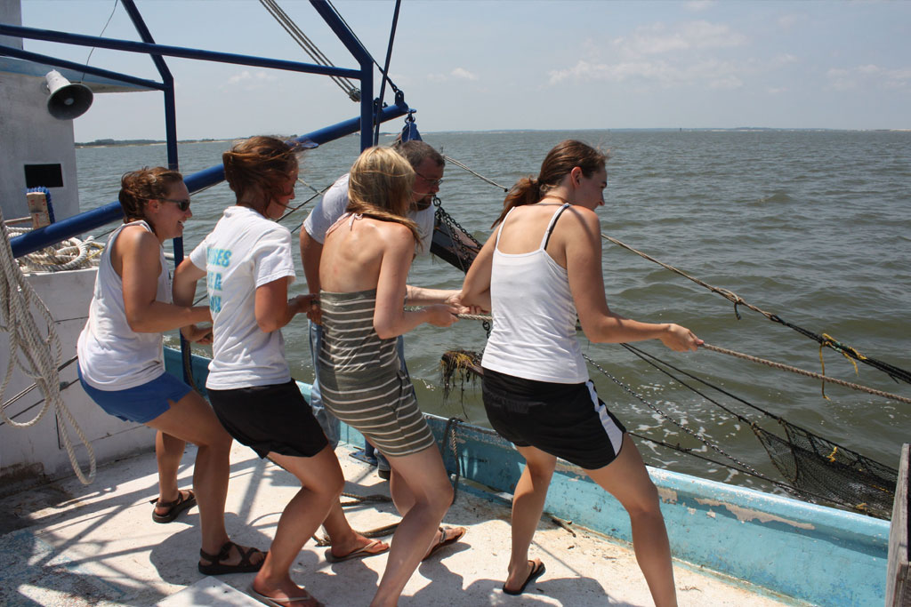 Students on RV Spartina pulling in the trawl net