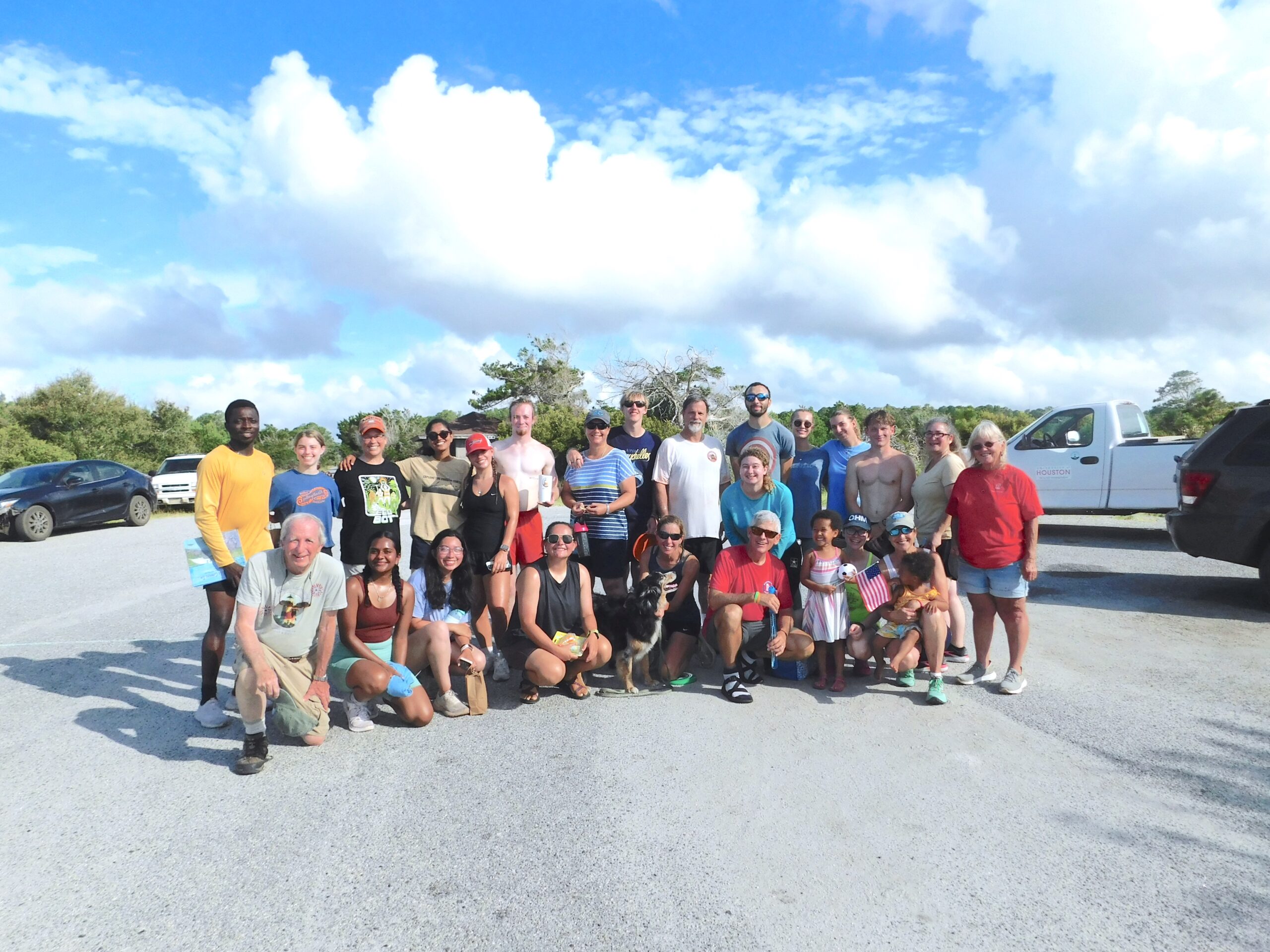Group photo of smiling visitors to UGAMI at the end of the run at Nannygoat Beach